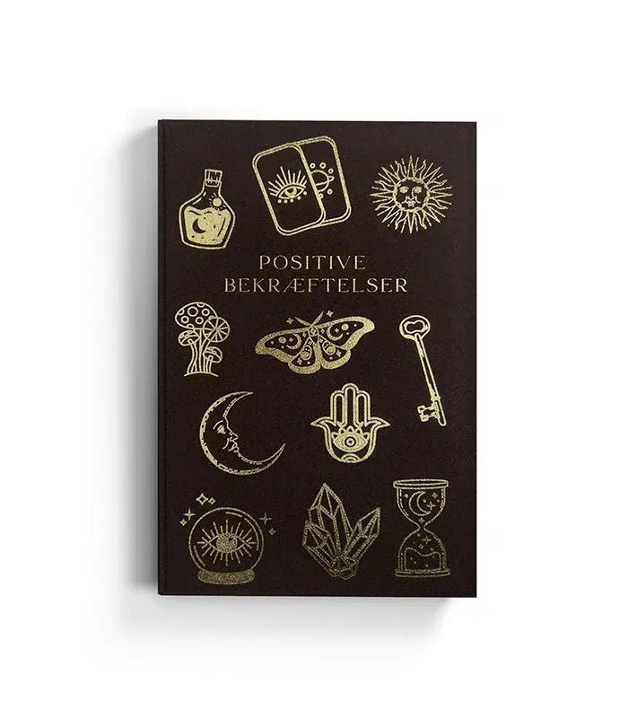Produktbillede af en bog med titlen Positive Bekræftelser med sort cover og gyldne illustrationer af symboler som øjne, nøgler, måner, sommerfugle, og krystaller